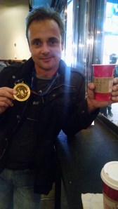 Sebastian and his medal! The coffee, if you can read, was made for "him" .. I told the barista that it was for "him" when they asked for a name, and they went with it. Ha!